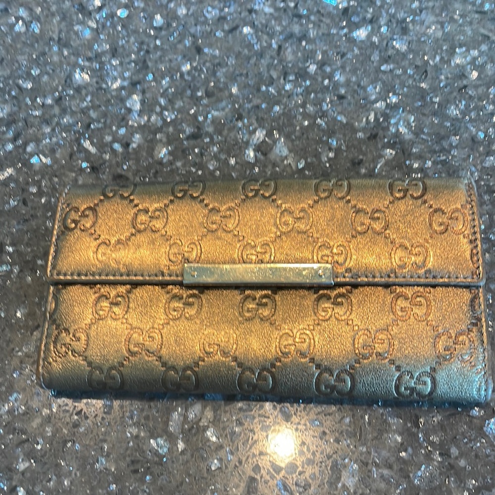 Dark gold Gucci leather embossed GG wallet